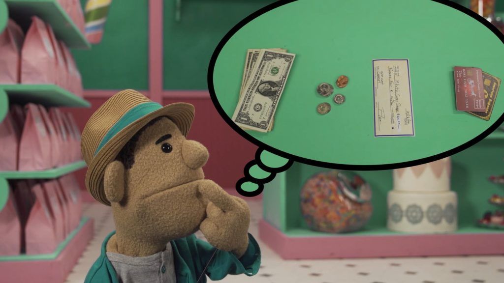 An image of Kevin, a puppet kid thinking about forms of payment