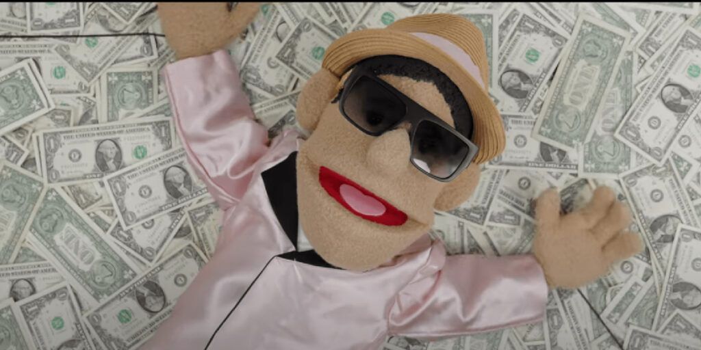Kevin puppet laying on a pile of money