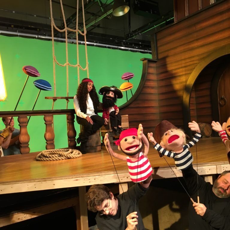 A behind the scenes image of the puppet video production