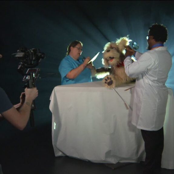 An image of the work going on behind the scenes for the puppet video shoot